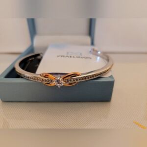 Cuff bracelet with  touch of rose gold leaves. Cubic zirconia center.